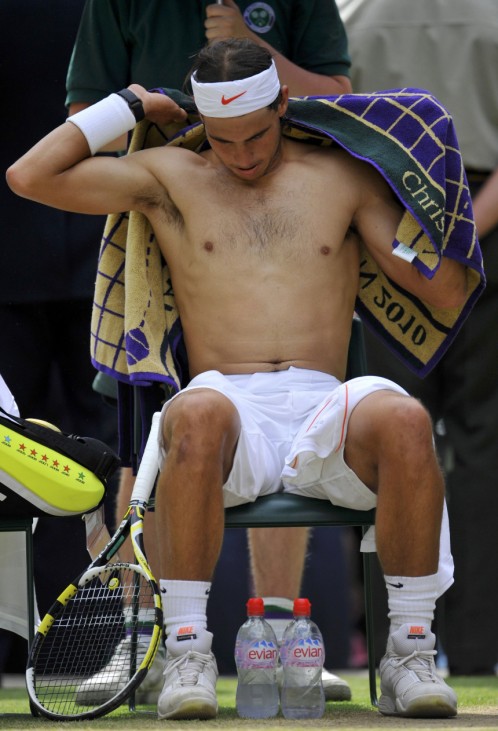 Spain's Rafael Nadal dries his back with a towel during his men's singles final match against Tomas Berdych of the Czech Republic at the 2010 Wimbledon tennis championships in London