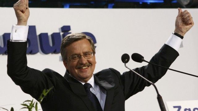 Poland's acting President Komorowski, speaker of the parliament and presidential candidate from Civic Platform Party (PO) waves to supporters at his election headquarters in Warsaw