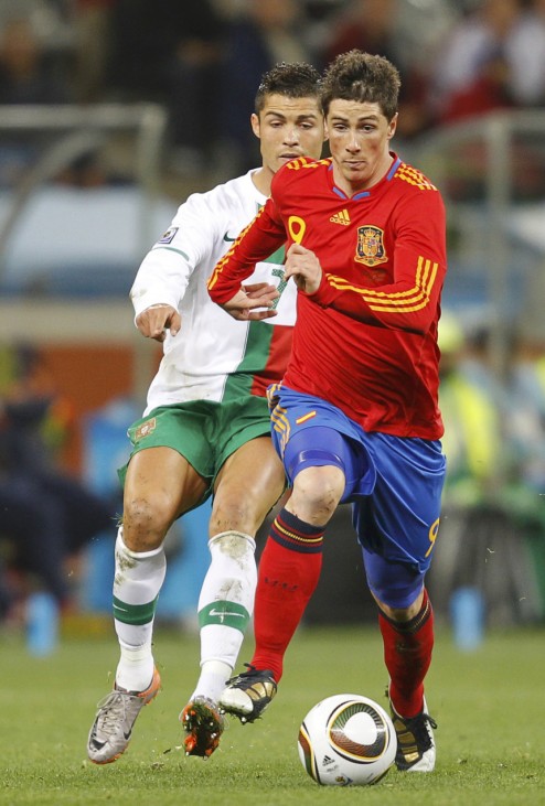 Spain's Torres runs with the ball past Portugal's Ronaldo during the 2010 World Cup second round soccer match at Green Point stadium in Cape Town