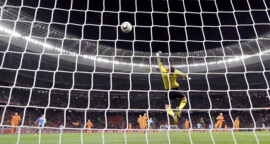 Uruguay's Diego Forlan scores a goal during their 2010 World Cup semi-final soccer match against Netherlands at Green Point stadium