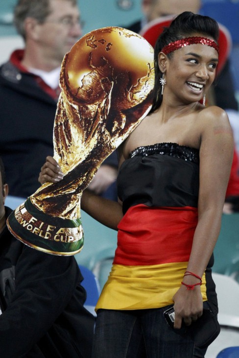 Germany fan holds cut-out of World Cup trophy before the 2010 World Cup semi-final soccer match between Germany and Spain in Durban