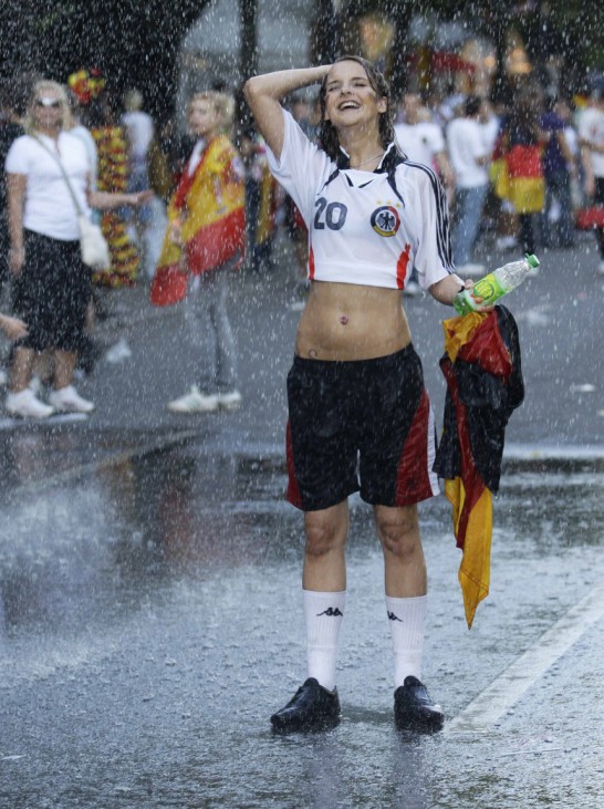 Soccer fan cools off under shower before screening of 2010 World Cup semi-final match between Germany and Spain in Berlin