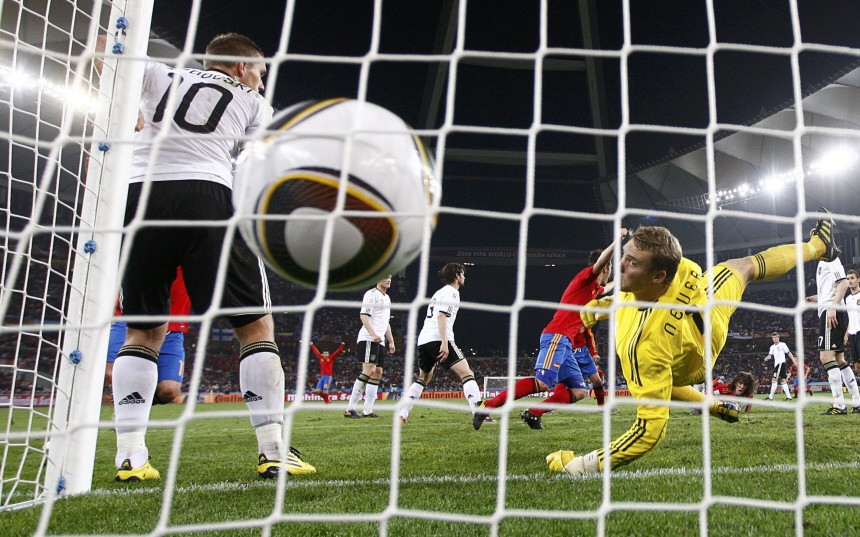 Spain's Puyol scores a goal past Germany's goalkeeper Neuer during the 2010 World Cup semi-final soccer match at Moses Mabhida stadium in Durban