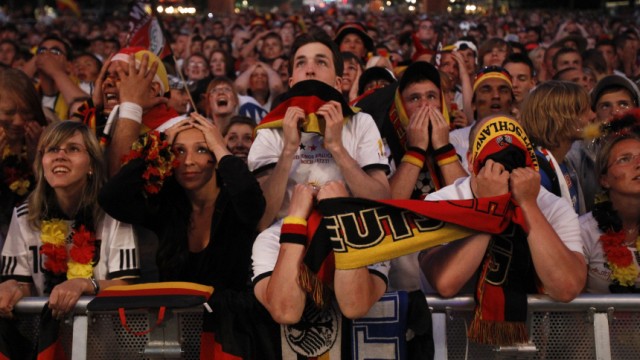 Soccer fans react during screening of 2010 World Cup semi-final soccer match match in Berlin