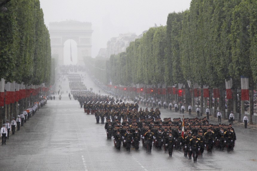 Students from France's Polytechnique school march down the Champs Elysees ahead of troops as part of the traditional Bastille Day parade in Paris