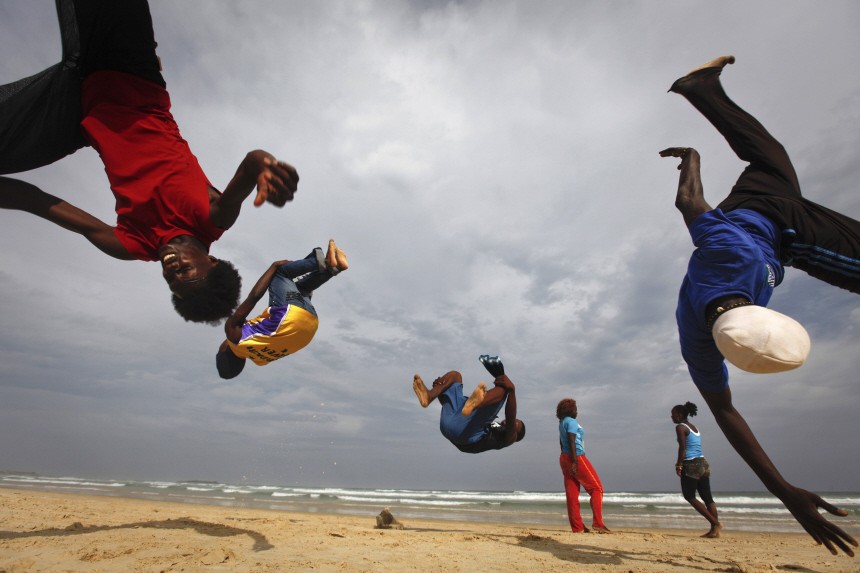 Performers from a group called Nomad Dance do somersaults during a training session at Yoff beach in Senegal's capital Dakar