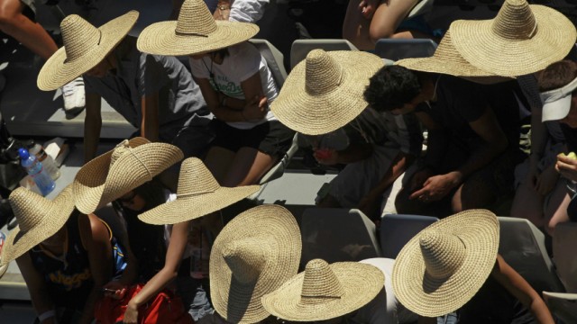 Spectators wear sombreros during the match between Petrova and Kuznetsova at the Australian Open in Melbourne