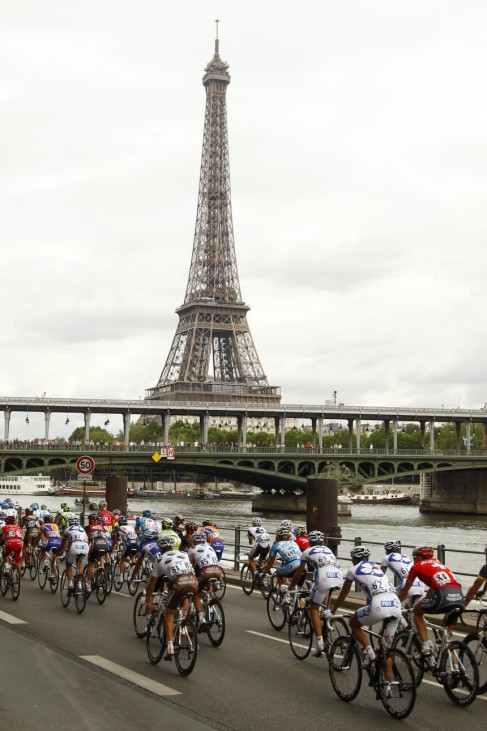 The pack of riders cycles past the Eiffel tower during the final 20th stage of the 97th Tour de France cycling race between Longjumeau and Paris