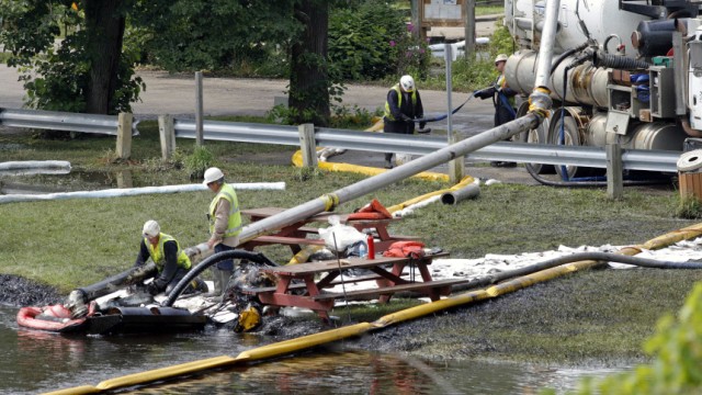 Workers Clean Up And Try To Contain Oil Spill In Michigan