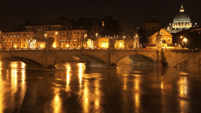 Saint Peter's Basilica is seen in downtown Rome behind the Tiber river