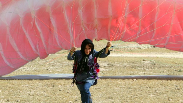 AFGHAN WOMAN PRACTICES PARAGLIDING IN KABUL