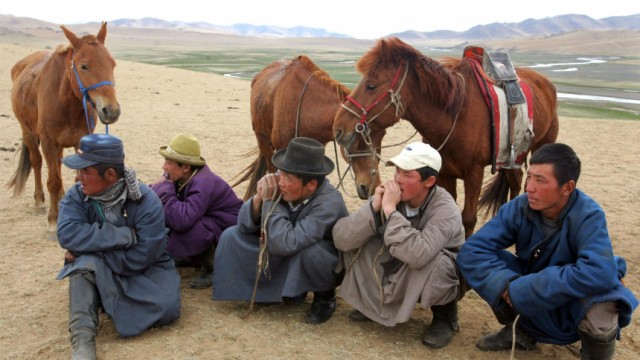 Mongolian nomads watch a polo practice match at Orkhon Valley near Kharkorin