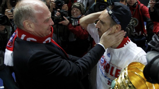 Bayern Munich's CEO Hoeness embraces Ribery holding the German Cup (DFB-Pokal) trophy after their 4-0 victory in the final match against Werder Bremen in Berlin