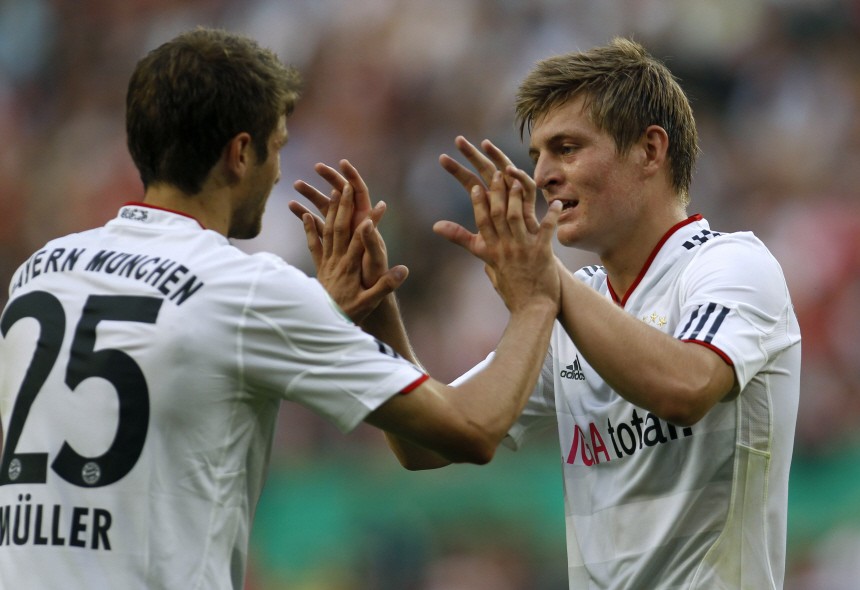 Bayern Munich's Kroos and Mueller celebrate a goal against Germania Windeck during the German Soccer Cup match in Cologne