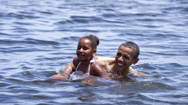 U.S. President Barack Obama and his daughter Sasha swim at Alligator Point in Panama City Beach Florida