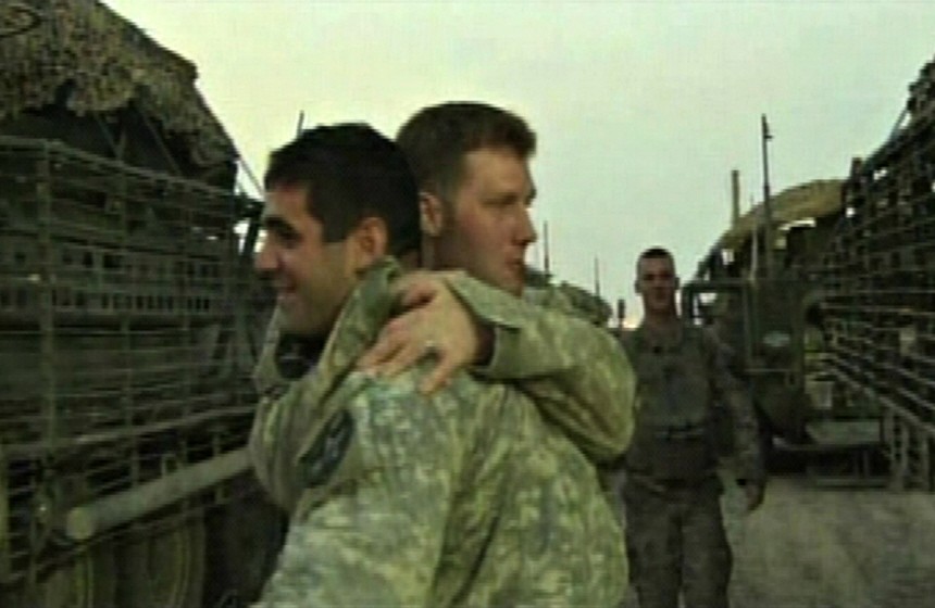 Video frame grab of Members of the last U.S. combat troops hugging after leaving Iraq and crossing the border into Kuwait