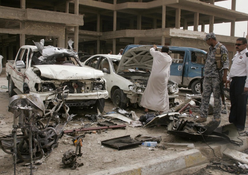 Damaged vehicles are seen at the site of a bomb attack in the city of Ramadi