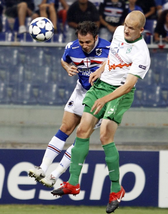 Sampdoria's Pazzini jumps and scores past Werder Bremen's Pasanen during their Champions League playoff second leg soccer match in Genoa