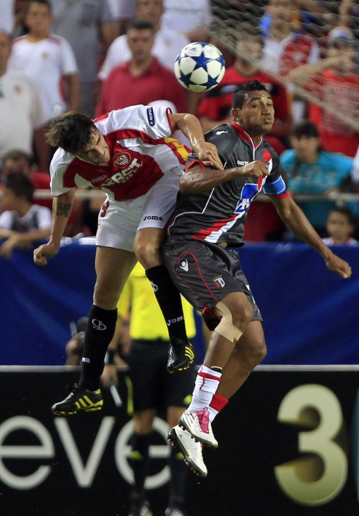 Sevilla's Cigarini challenges Braga's Vandinho for the ball during their Champions League playoff round soccer match in Seville