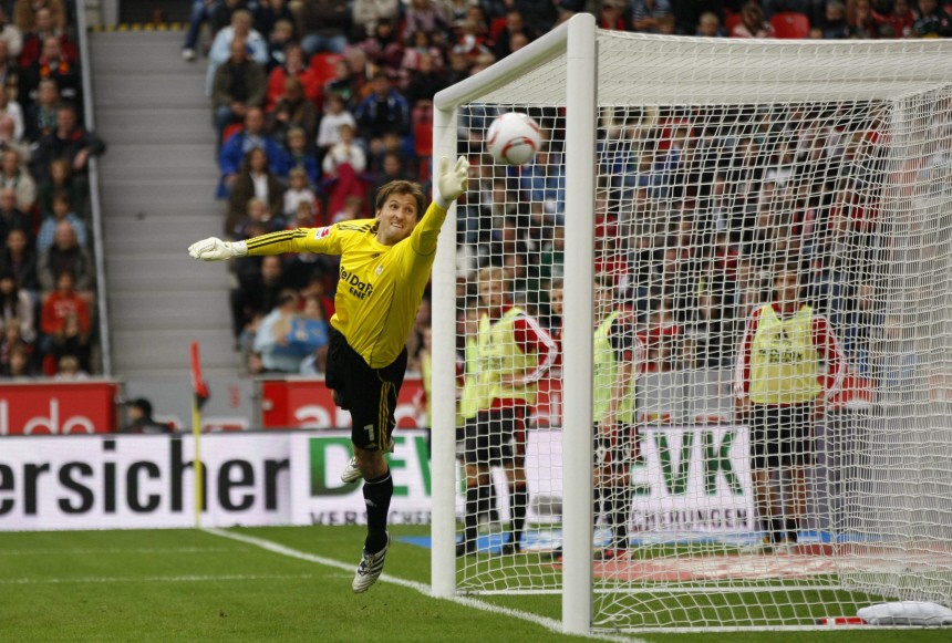 Bayer Leverkusen's Adler jumps for a ball scored by Borussia Moenchengladbach's Juan Arango during the German Bundesliga soccer match in Leverkusen