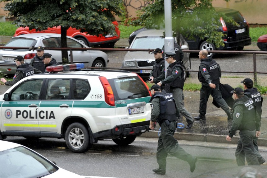 Slovak police run on a street in the district of Devinska Nova Ves