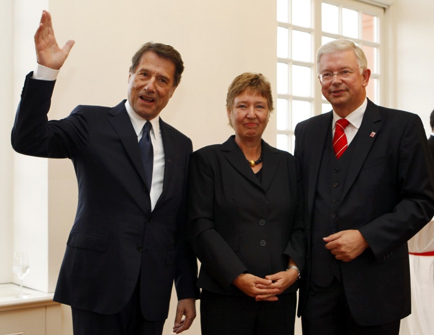 Koch, the outgoing Premier of Germany's federal state of Hesse, his wife Anke and German singer Juergens pose for the media during a reception in Wiesbaden