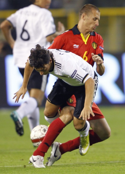 Belgium's Simons tackles Germany's Ozil during their Euro 2012 qualifying soccer match in Brussels
