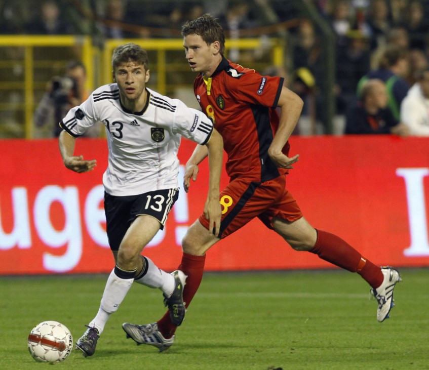 Belgium's Jan Vertonghen (R) fights for the ball with Germany's Thomas Muller during their Euro 2012 qualifying soccer match at the King Baudouin stadium in Brussels