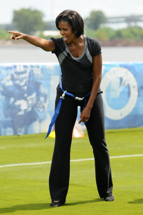 U.S. first lady Obama points to a player while she plays flag football during her 'Let's Move' campaign to fight childhood obesity in New Orleans