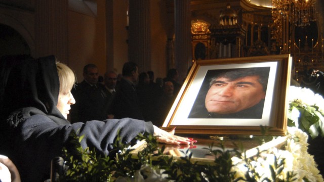 A mourner touches the Turkish-Armenian editor Hrant Dink's coffin during his funeral service in Istanbul