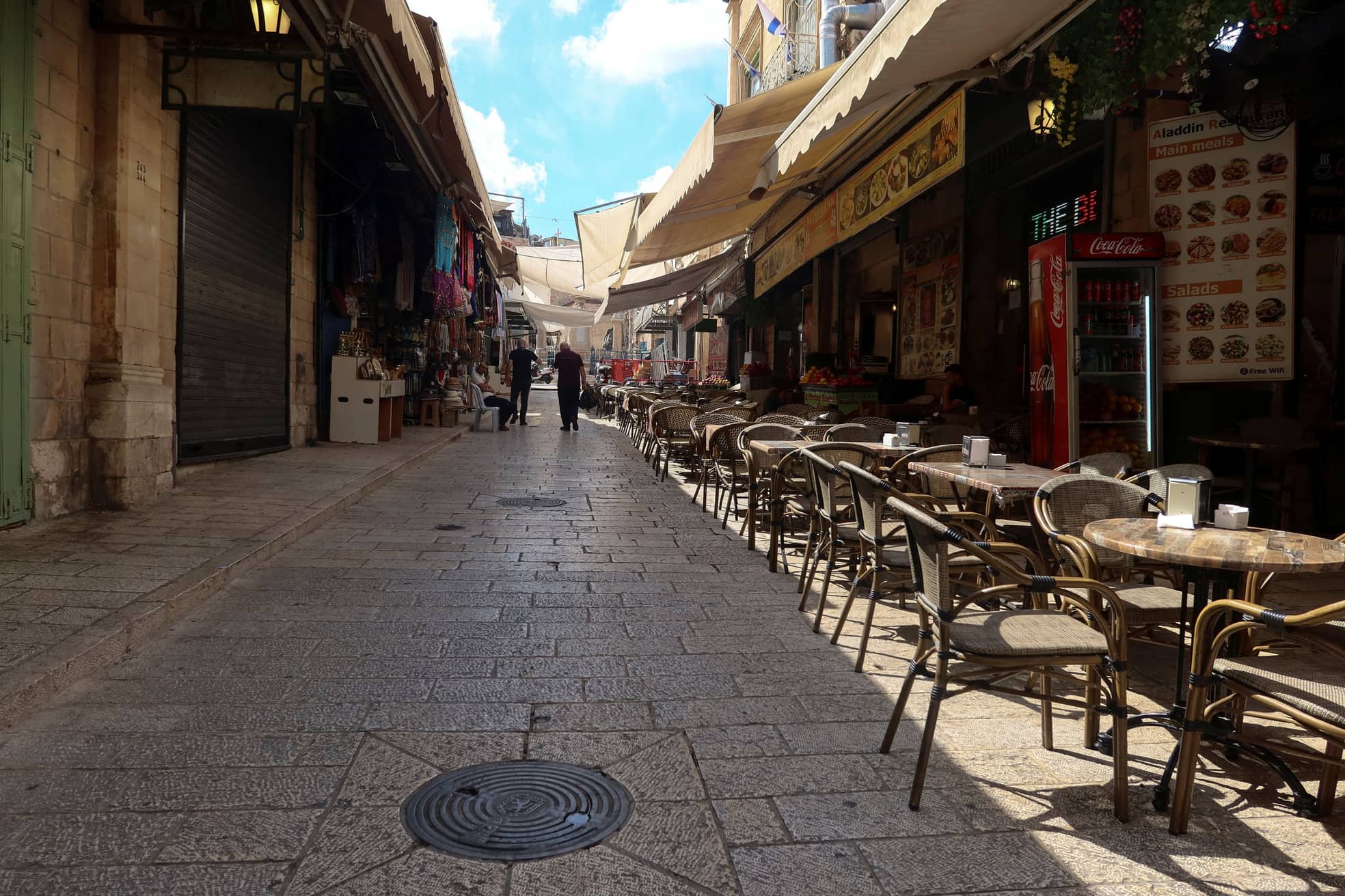 A man walks past a church through a deserted alley in Old Jerusalem with most shops closed due to the ongoing war between Israel and the Hamas movement, on October 11, 2023. Israeli cities have been eerily quiet and tense, with some residents noting a growing sense of fear and distrust between Jews and members of the Arab-Israeli minority, while Israeli border police shot dead two Palestinians in annexed east Jerusalem on October 11 after they threw fireworks and rocks at fellow officers, the force said.