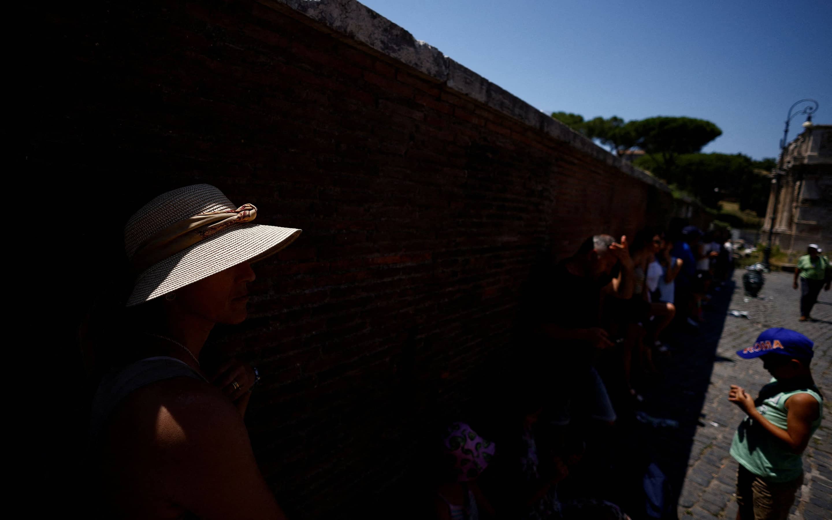 In Rom sucht eine Frau Schutz vor der Sonne.