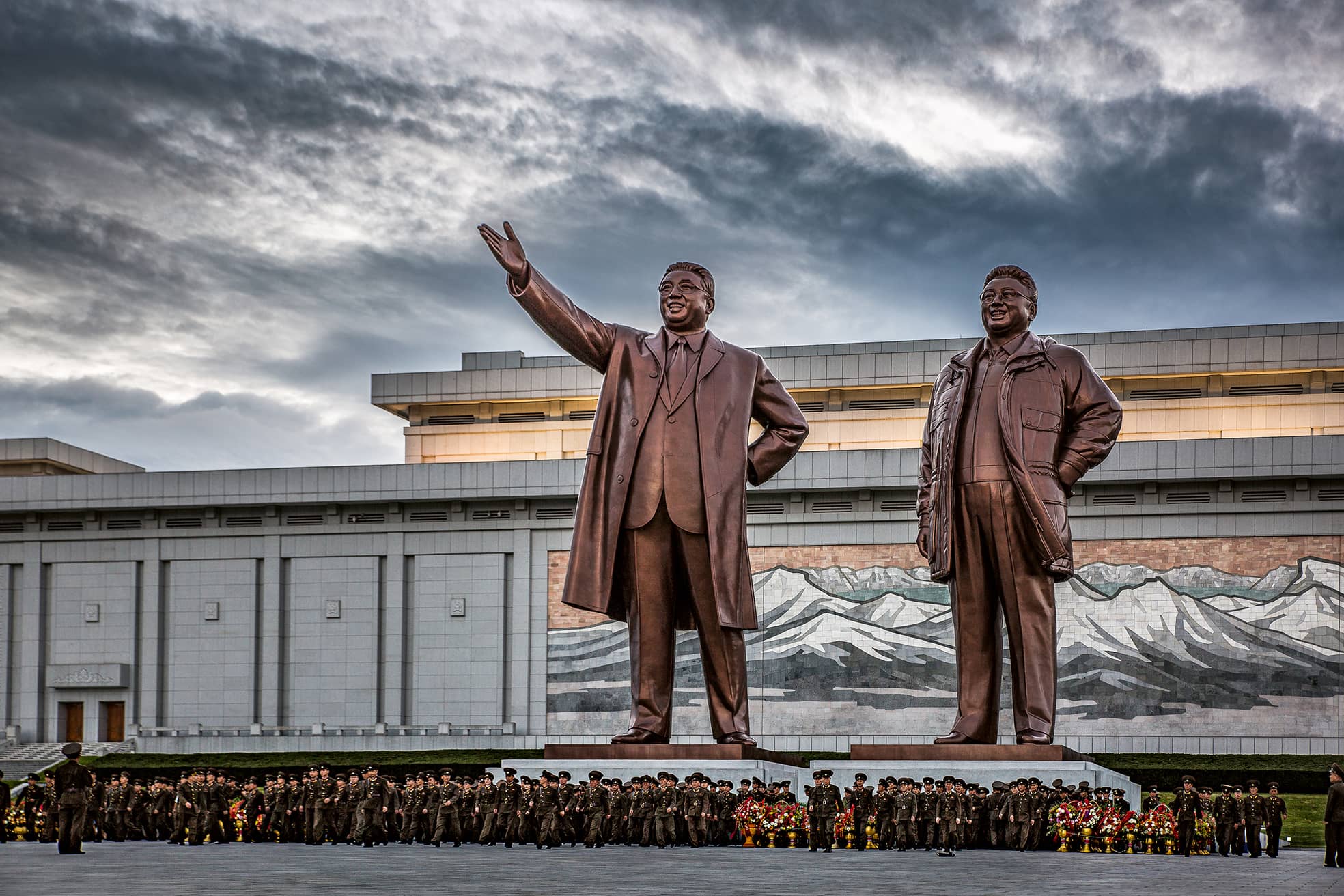 Soldaten in Pjöngjang unterhalb der monströsen Bronzestatuen von Kim Il Sung und Kim Jong Il.